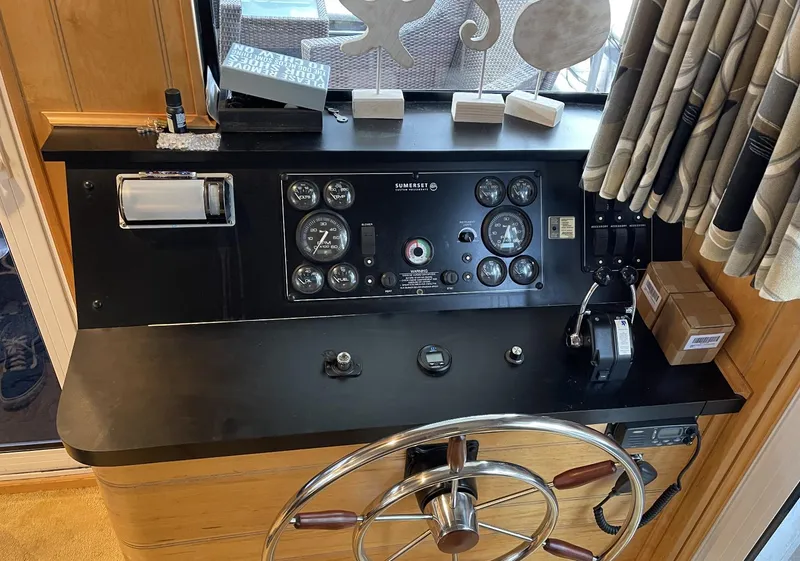 Slide: The Image of Control panel of a 2000 Sumerset 16x75 houseboat with steering wheel and gauges. - 5