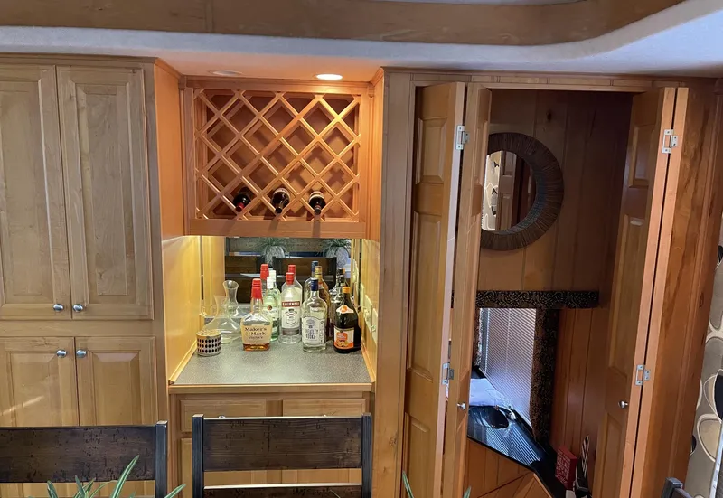 Slide: The Image of Sumerset 16x75 houseboat interior with bar area, wine rack, and wooden cabinetry, year 2000. - 9