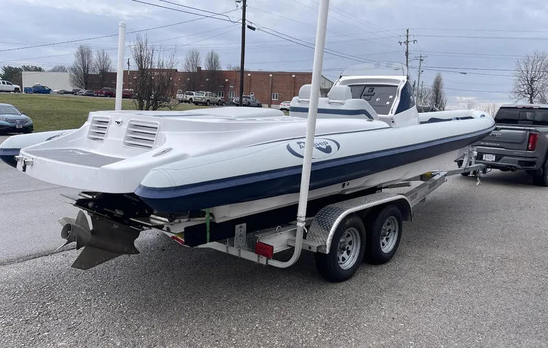 Slide: The Image of 2022 Airship 300 DS boat on trailer, parked outdoors. - 11