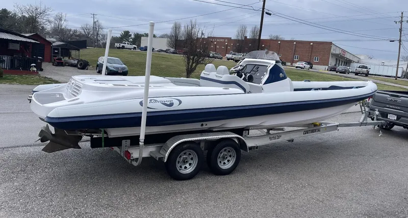 Slide: The Image of 2022 Airship 300 DS boat on trailer in parking lot. - 12
