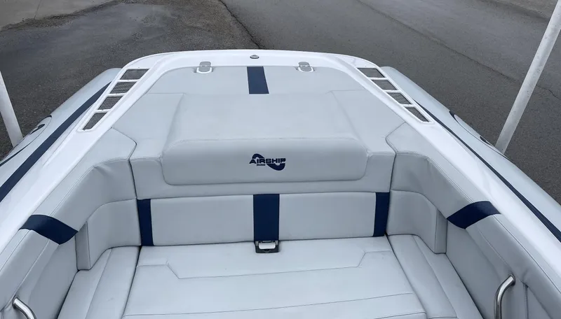 Slide: The Image of 2022 Airship 300 DS boat interior with white and blue seating. - 17