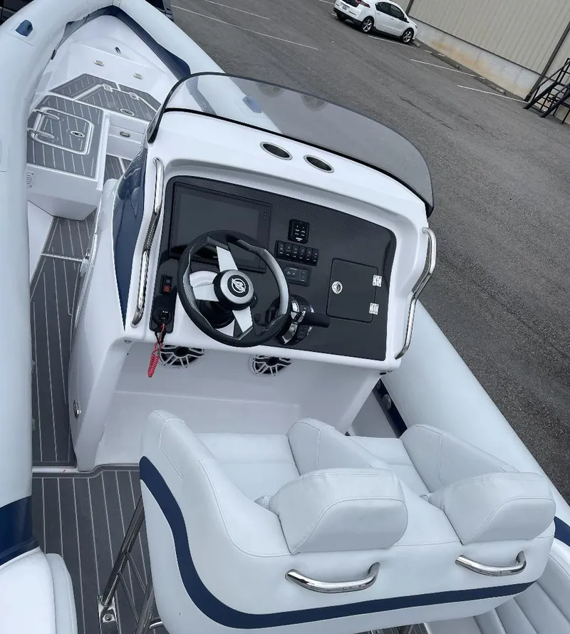 Slide: The Image of 2022 Airship 300 DS boat interior with steering console and seating. - 20