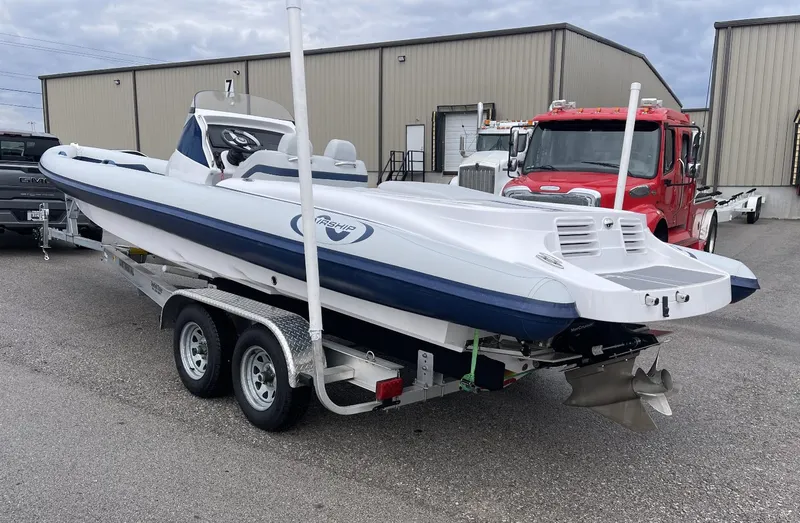 Slide: The Image of Airship 300 DS 2022 boat on trailer, parked near industrial buildings. - 9