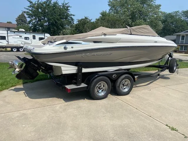 Slide: The Image of 2014 Crownline 215 SS boat on trailer, covered, parked on driveway. - 2