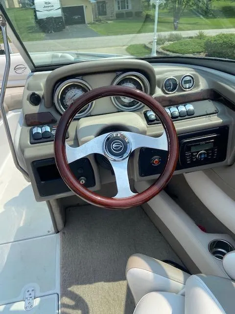 Slide: The Image of Interior view of a 2014 Crownline 215 SS boat with wooden steering wheel. - 4