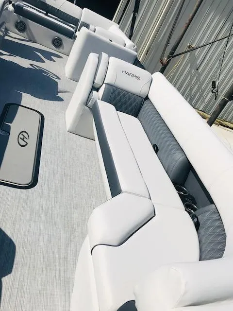 Slide: The Image of 2024 Harris Sunliner 250 boat interior with white and gray seating. - 10