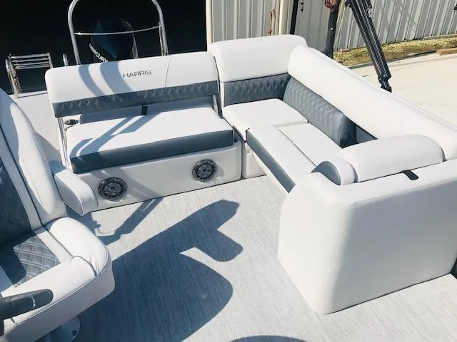 Slide: The Image of 2024 Harris Sunliner 250 boat interior with white and gray seating. - 11