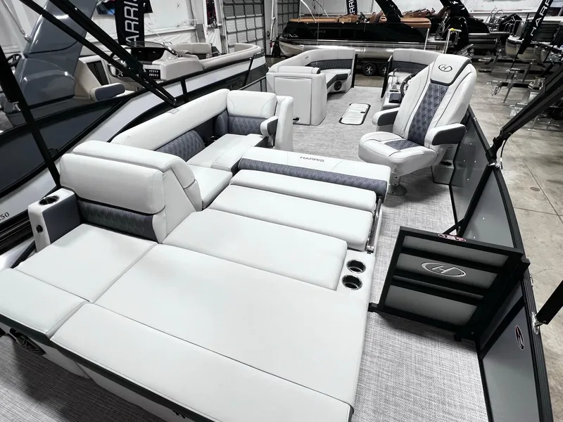Slide: The Image of 2024 Harris Sunliner 250 pontoon boat with luxurious seating and modern design. - 16