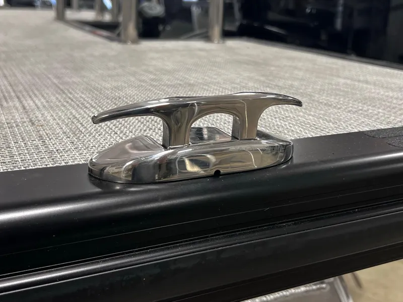 Slide: The Image of 2024 Harris Sunliner 250 boat cleat on textured deck surface. - 17