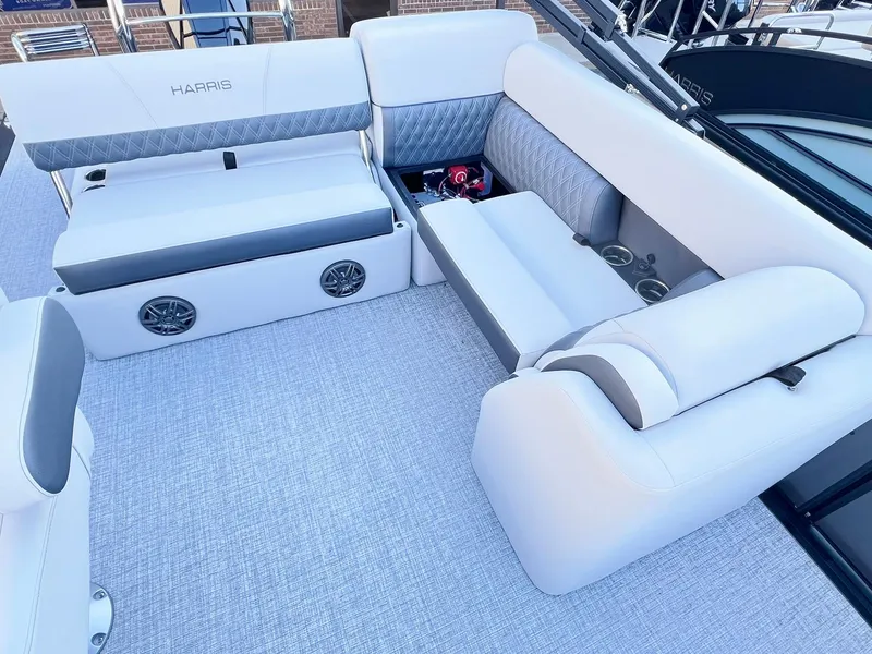 Slide: The Image of 2024 Harris Sunliner 250 boat interior with plush seating and built-in speakers. - 19