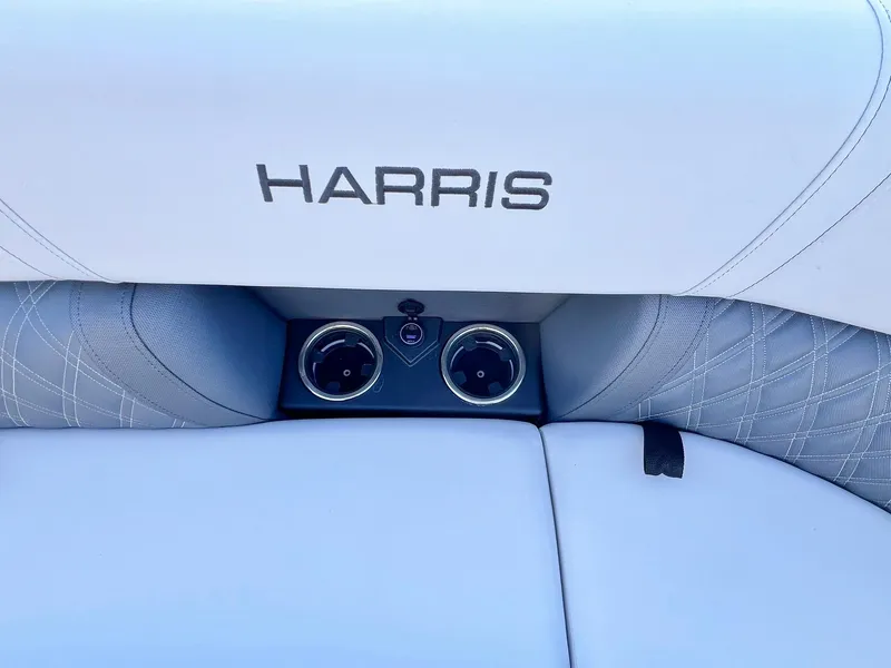 Slide: The Image of 2024 Harris Sunliner 250 boat interior with cup holders and logo. - 20