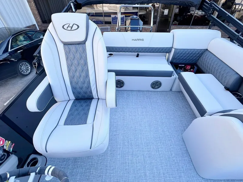 Slide: The Image of 2024 Harris Sunliner 250 boat interior with plush seating and modern design. - 23