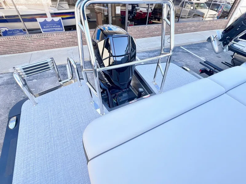 Slide: The Image of 2024 Harris Sunliner 250 boat with sleek engine and spacious deck. - 24