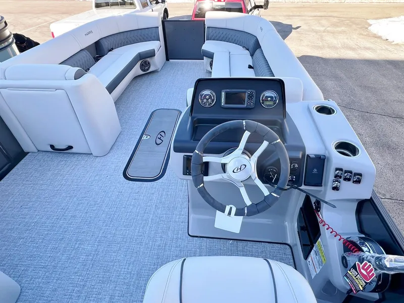 Slide: The Image of 2024 Harris Sunliner 250 boat interior with modern helm and spacious seating. - 5