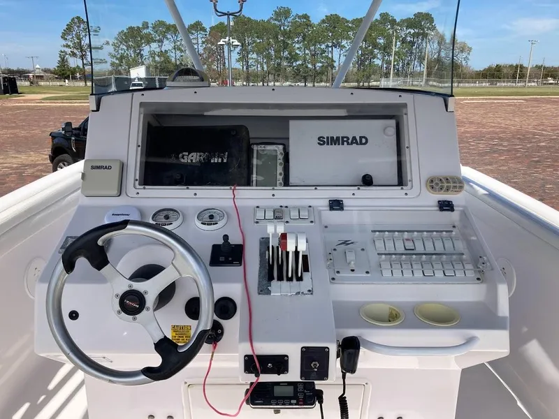 Slide: The Image of 2005 Donzi 35 ZFC Daytona boat dashboard with Simrad navigation system and steering wheel. - 15