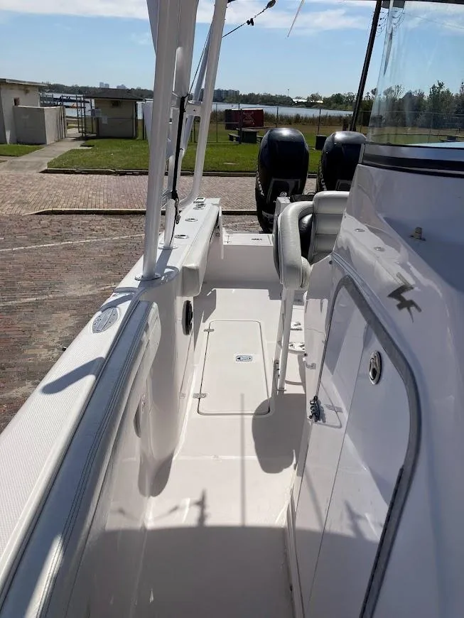 Slide: The Image of 2005 Donzi 35 ZFC DAYTONA boat deck with dual engines, docked outdoors. - 23