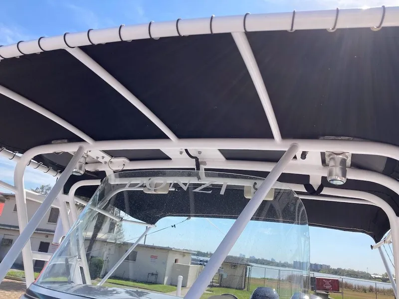 Slide: The Image of 2005 Donzi 35 ZFC Daytona boat with canopy and windshield, docked under clear sky. - 25