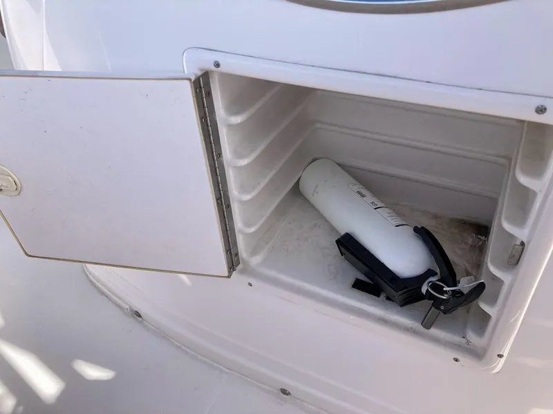Slide: The Image of Open storage compartment on 2005 Donzi 35 ZFC DAYTONA with fire extinguisher inside. - 27