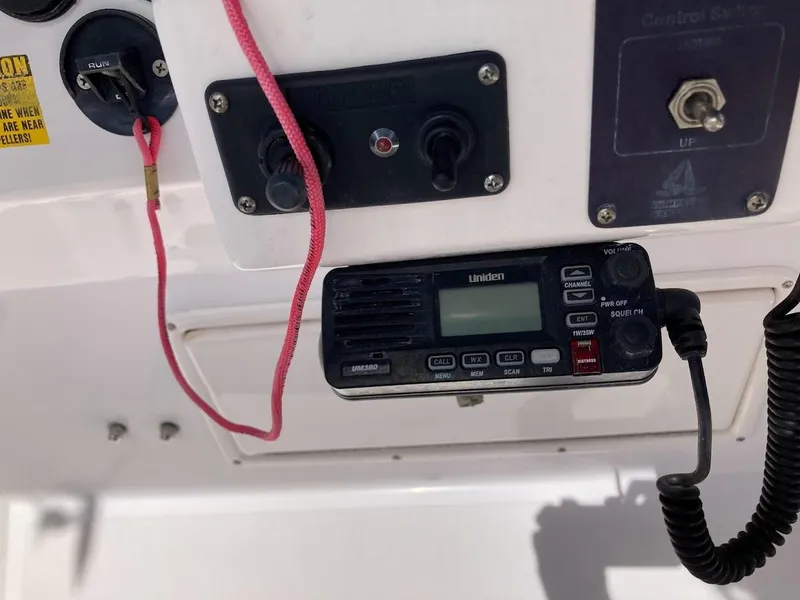 Slide: The Image of Control panel of a 2005 Donzi 35 ZFC DAYTONA boat with radio and switches. - 29