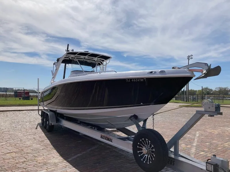 Slide: The Image of 2005 Donzi 35 ZFC DAYTONA boat on trailer under clear sky. - 3