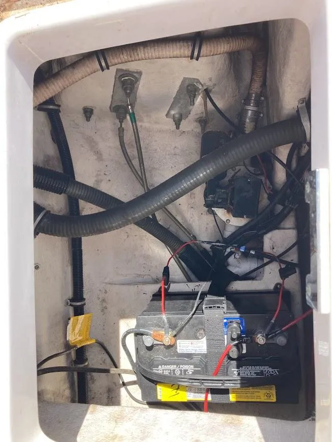 Slide: The Image of 2005 Donzi 35 ZFC DAYTONA boat battery compartment with wiring and hoses. - 42