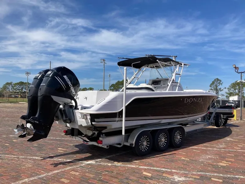 Slide: The Image of 2005 Donzi 35 ZFC DAYTONA boat on trailer, parked outdoors under blue sky. - 5