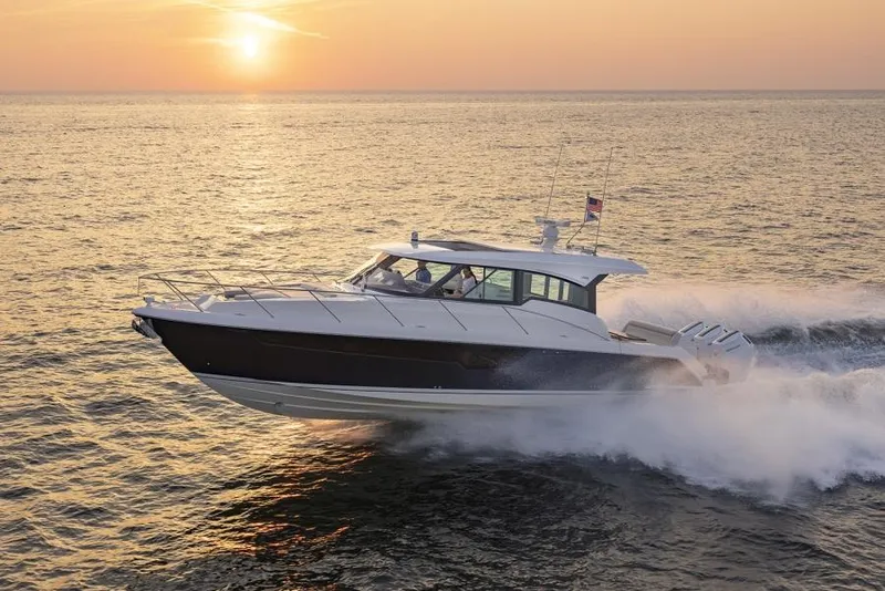 The Image of 2025 Tiara Yachts 48LE cruising at sunset on open water. - 0