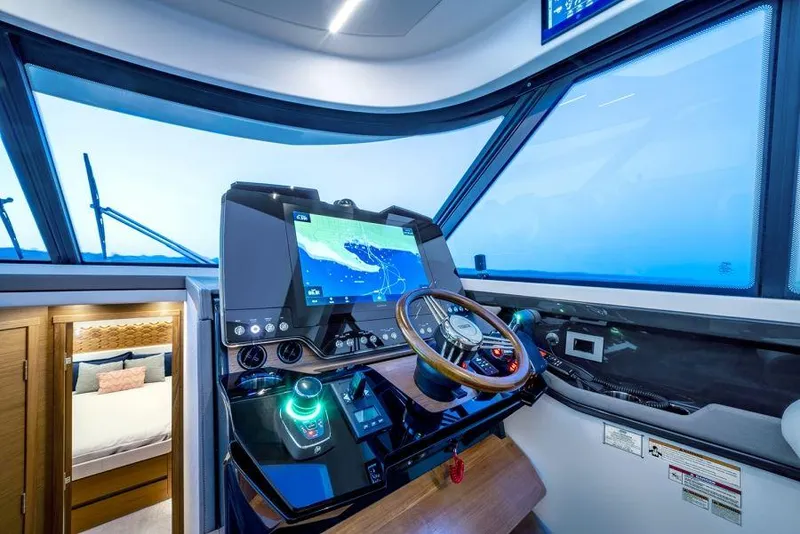 Slide: The Image of Helm of 2025 Tiara Yachts 48LE with advanced navigation system. - 5