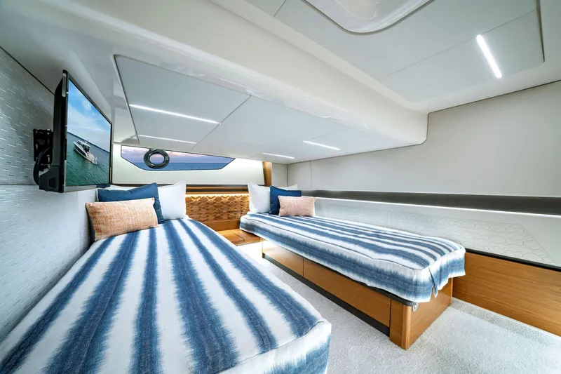 Slide: The Image of Luxurious cabin interior of 2025 Tiara Yachts 48LE with twin beds and modern decor. - 8