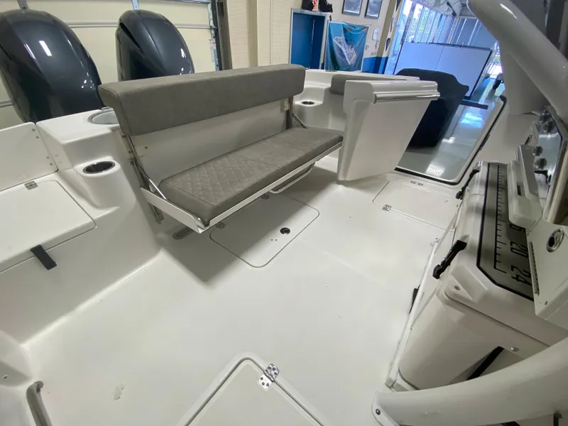 Slide: The Image of 2023 Sea Pro 259 Deep V CC boat interior with seating and dual outboard motors. - 3