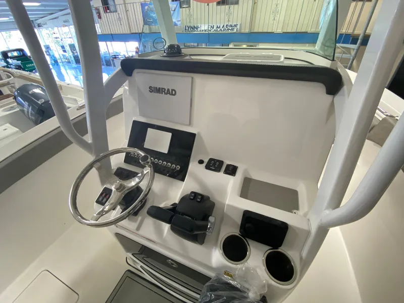 Slide: The Image of 2023 Sea Pro 259 Deep V CC boat console with steering wheel and Simrad electronics. - 4
