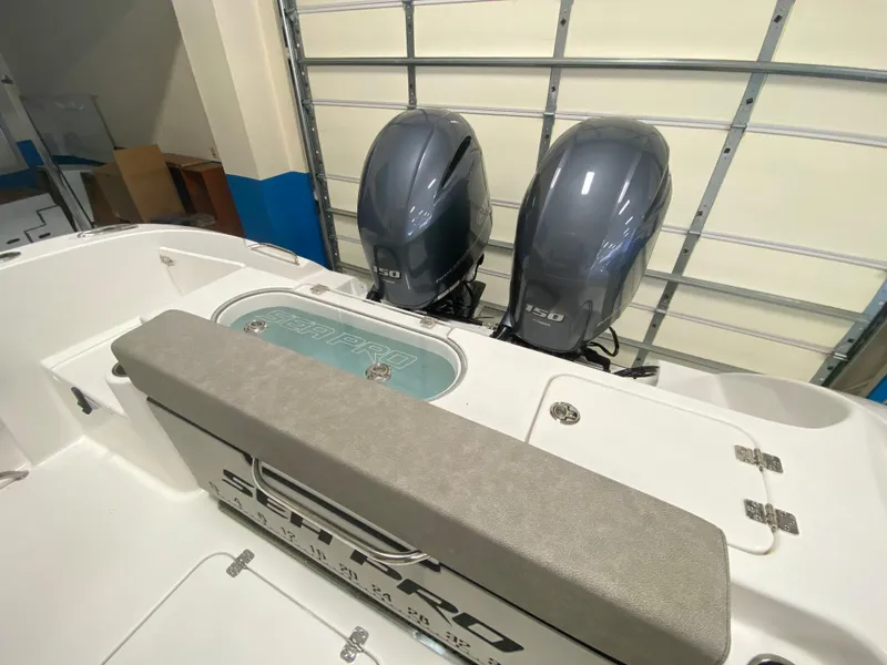 Slide: The Image of 2023 Sea Pro 259 Deep V CC boat with twin outboard engines in a garage. - 8