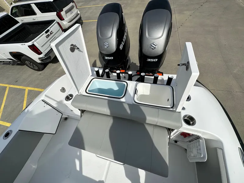 Slide: The Image of 2026 Cape Horn 32 XS boat with dual Suzuki 350 engines and open storage compartments. - 10