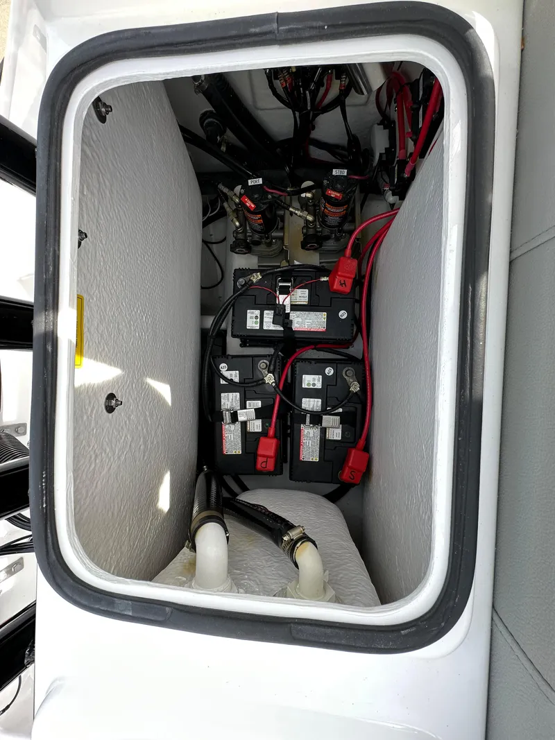 Slide: The Image of 2026 Cape Horn 32 XS boat battery compartment with wiring and connections. - 12