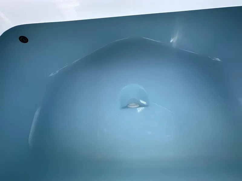 Slide: The Image of Interior view of a 2026 Cape Horn 32 XS boat hull, showcasing smooth blue finish. - 14