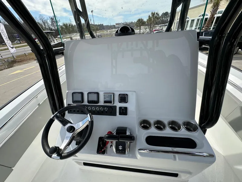 Slide: The Image of Center console of 2026 Cape Horn 32 XS boat with steering wheel and controls. - 24