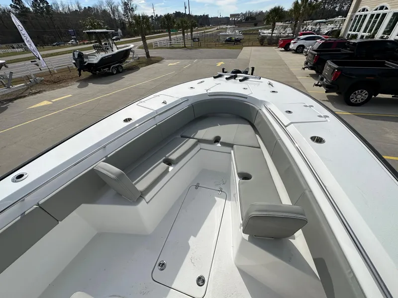 Slide: The Image of 2026 Cape Horn 32 XS boat with spacious seating and sleek design in a parking lot. - 28
