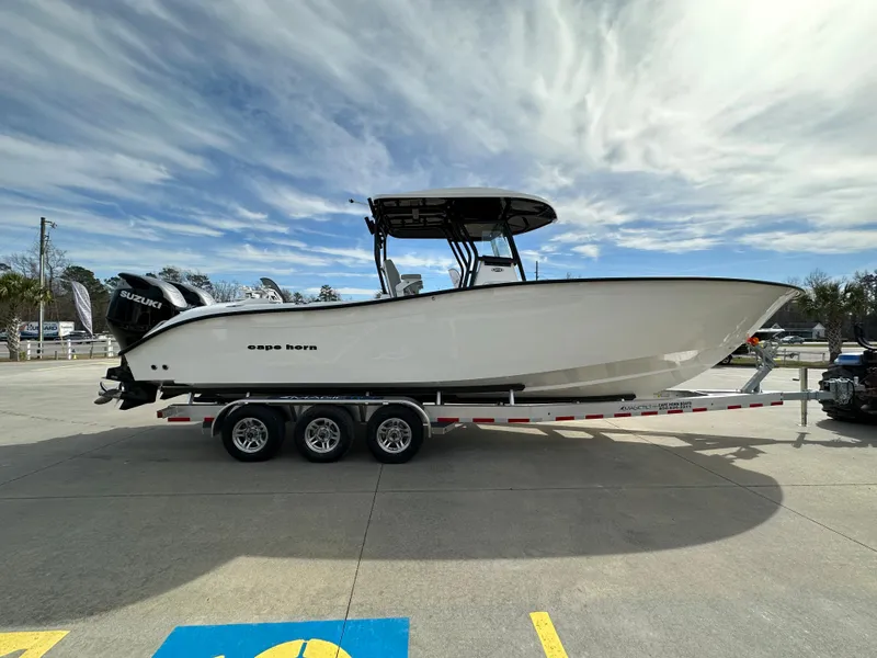 Slide: The Image of 2026 Cape Horn 32 XS boat on trailer, parked outdoors under a cloudy sky. - 5