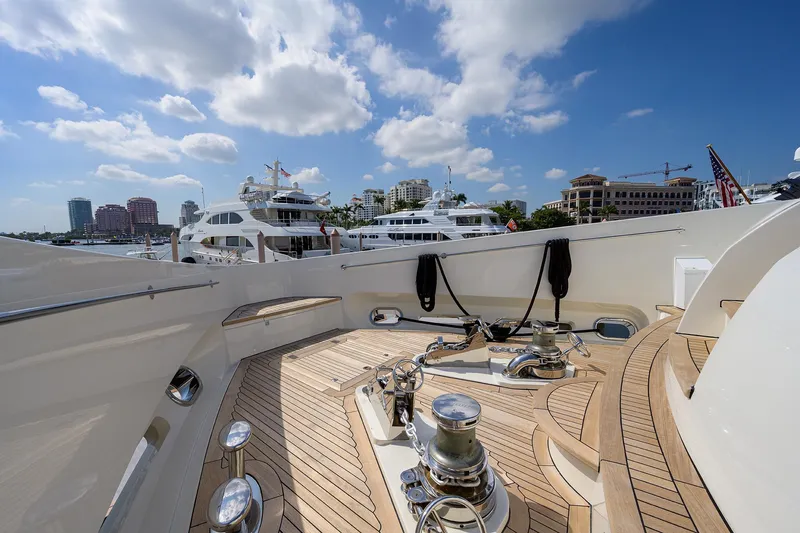 Slide: The Image of Sunseeker Trideck 2009 yacht deck with marina view, clear sky, and luxury boats. - 17