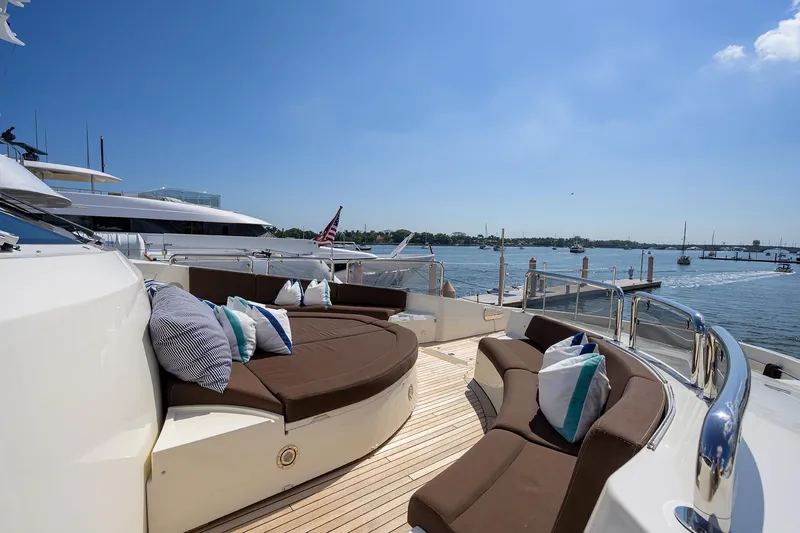 Slide: The Image of 2009 Sunseeker Trideck yacht with luxurious deck seating and scenic ocean view. - 21