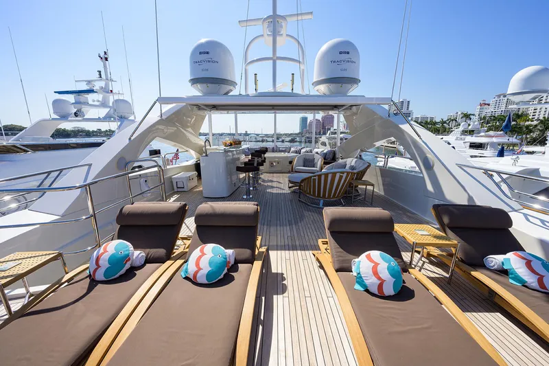 Slide: The Image of Luxurious 2009 Sunseeker Trideck yacht with sun loungers and scenic marina view. - 24