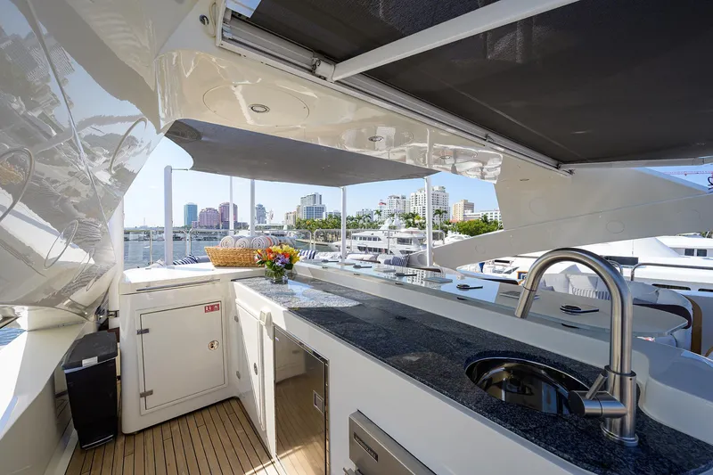 Slide: The Image of Luxurious 2009 Sunseeker Trideck yacht with outdoor kitchen and city skyline view. - 27