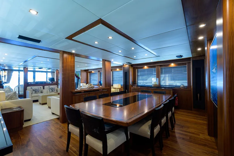 Slide: The Image of Luxurious dining area on a 2009 Sunseeker Trideck yacht with elegant wooden interiors. - 35
