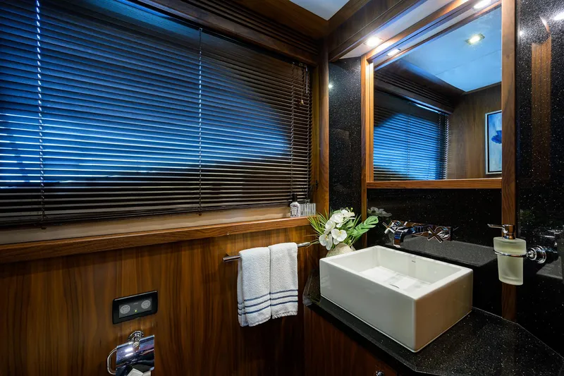 Slide: The Image of Luxurious bathroom on a 2009 Sunseeker Trideck yacht with modern sink and wooden accents. - 39