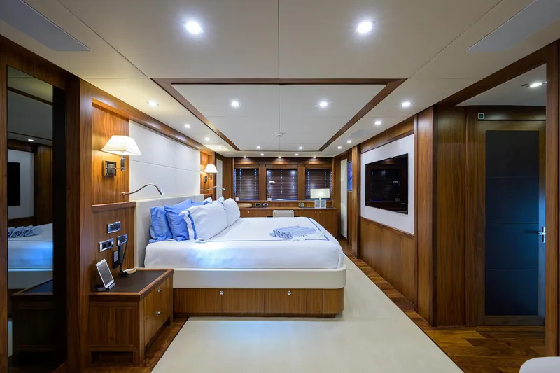 Slide: The Image of Luxurious master bedroom on a 2009 Sunseeker Trideck yacht with modern wood paneling. - 43
