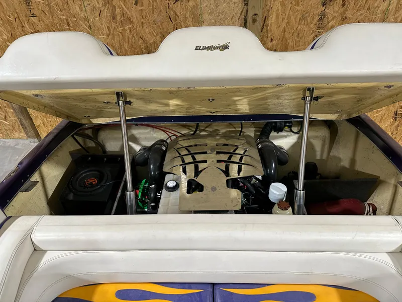 Slide: The Image of 2005 Eliminator 260 Eagle XP boat engine compartment with open hatch, showcasing engine details. - 10