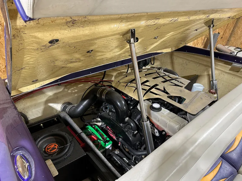 Slide: The Image of Open engine compartment of a 2005 Eliminator 260 Eagle XP boat, showcasing engine components. - 11