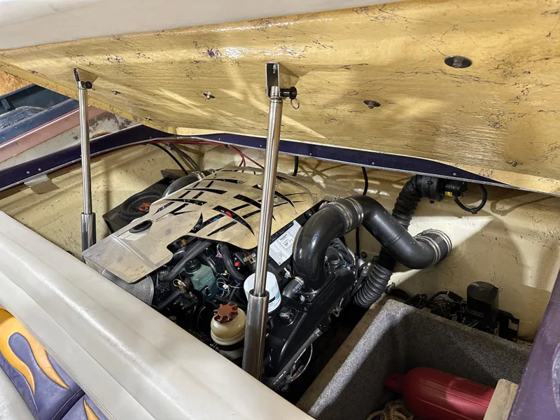 Slide: The Image of Open engine compartment of 2005 Eliminator 260 Eagle XP boat, showcasing engine details. - 12