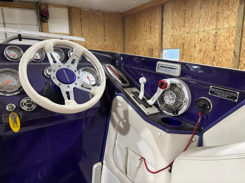 Slide: The Image of Interior of a 2005 Eliminator 260 Eagle XP boat with steering wheel and controls. - 15