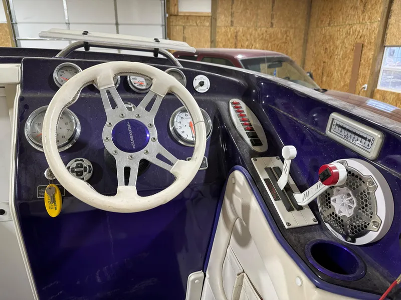 Slide: The Image of 2005 Eliminator 260 Eagle XP boat dashboard with steering wheel and control panel. - 16